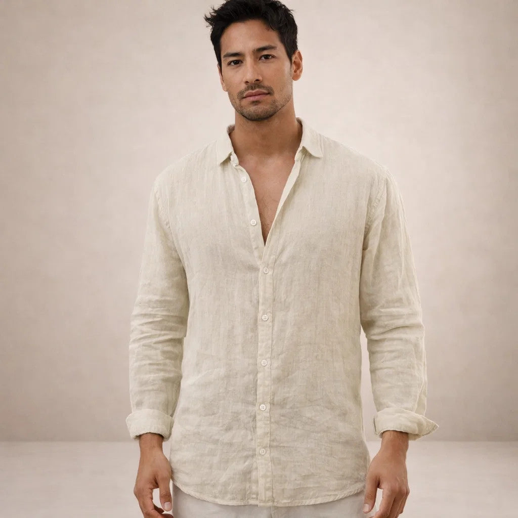 Model facing the camera in a natural beige linen shirt with creased texture, open collar and rolled sleeves. 11