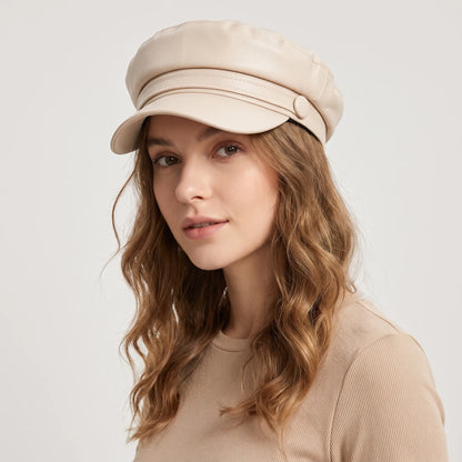 Woman with long wavy hair wearing the cream baker boy hat, looking over her shoulder 19