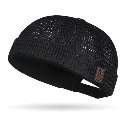 Black open weave brimless cap with a small patch on the turned-up cuff 19