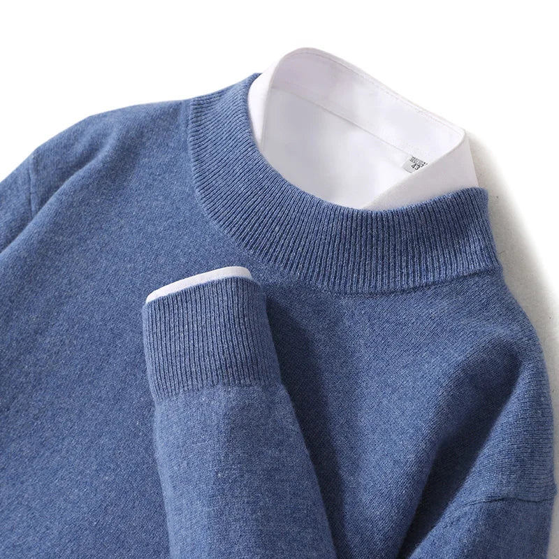 Close-up of the denim blue jumper's ribbed mock neck and cuff over a white shirt 19