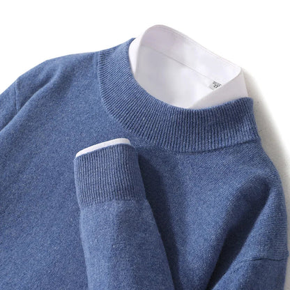 Close-up of the denim blue jumper's ribbed mock neck and cuff over a white shirt 19
