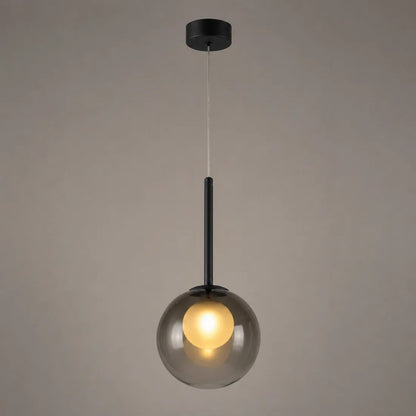 Lit smoke grey globe pendant with black stem and ceiling plate against a taupe backdrop 10