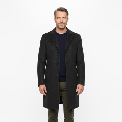 Man wearing the open coat over a navy jumper and olive trousers, seen from the front 2