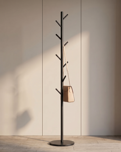 Black coat rack standing against a panelled wall, with a beige shoulder bag hanging from one of its angled hooks. 1