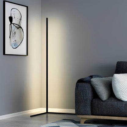Black corner lamp with a soft white glow in a grey living room beside a dark sofa 5