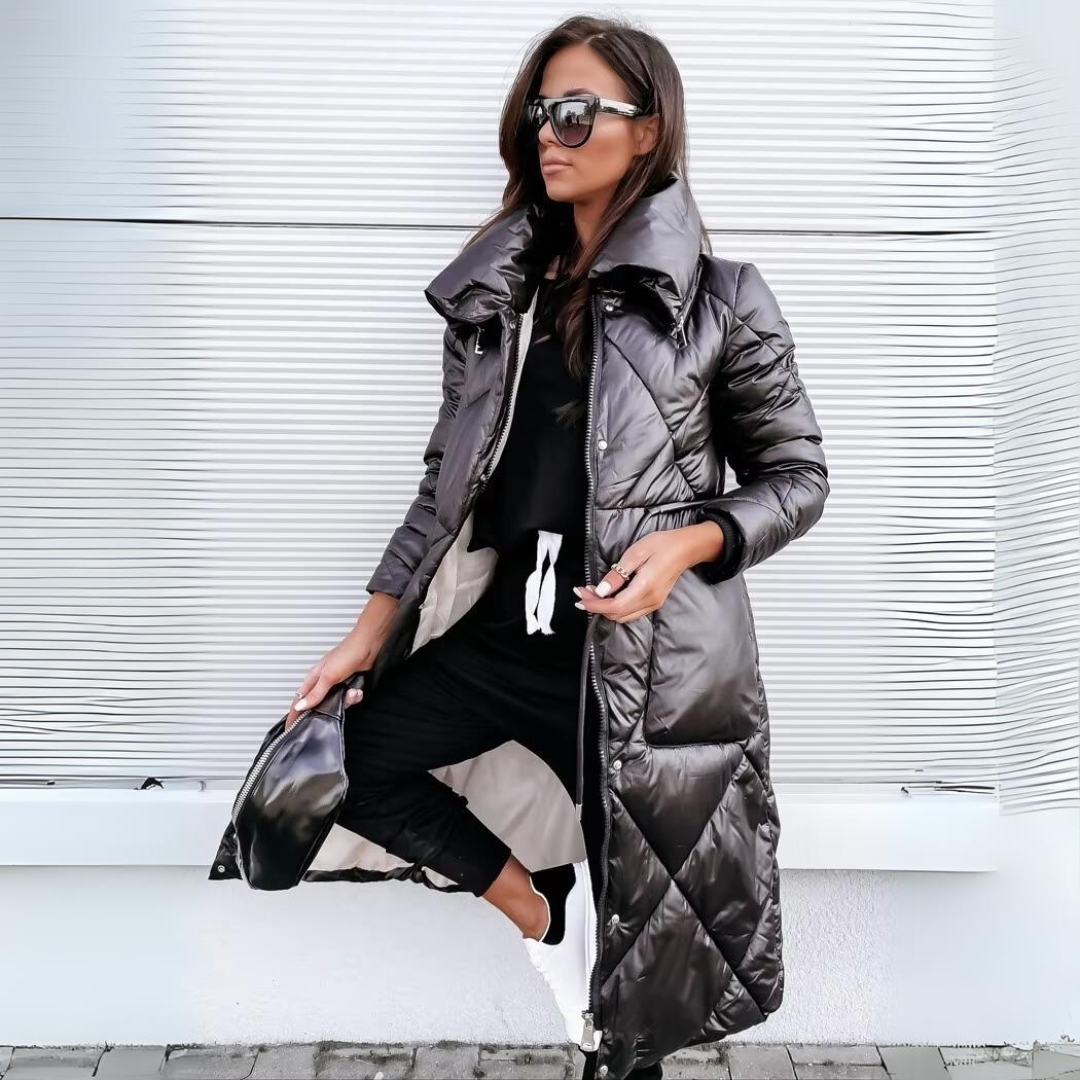 Woman in sunglasses wears the glossy black diamond-quilted long puffer coat with a wide collar, open over black joggers, holding a small black bag. 1