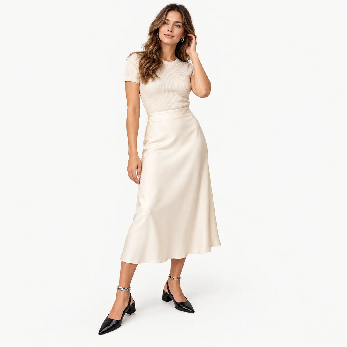 Model in black croc-embossed slingbacks with an ankle chain, styled with a cream satin midi skirt 1