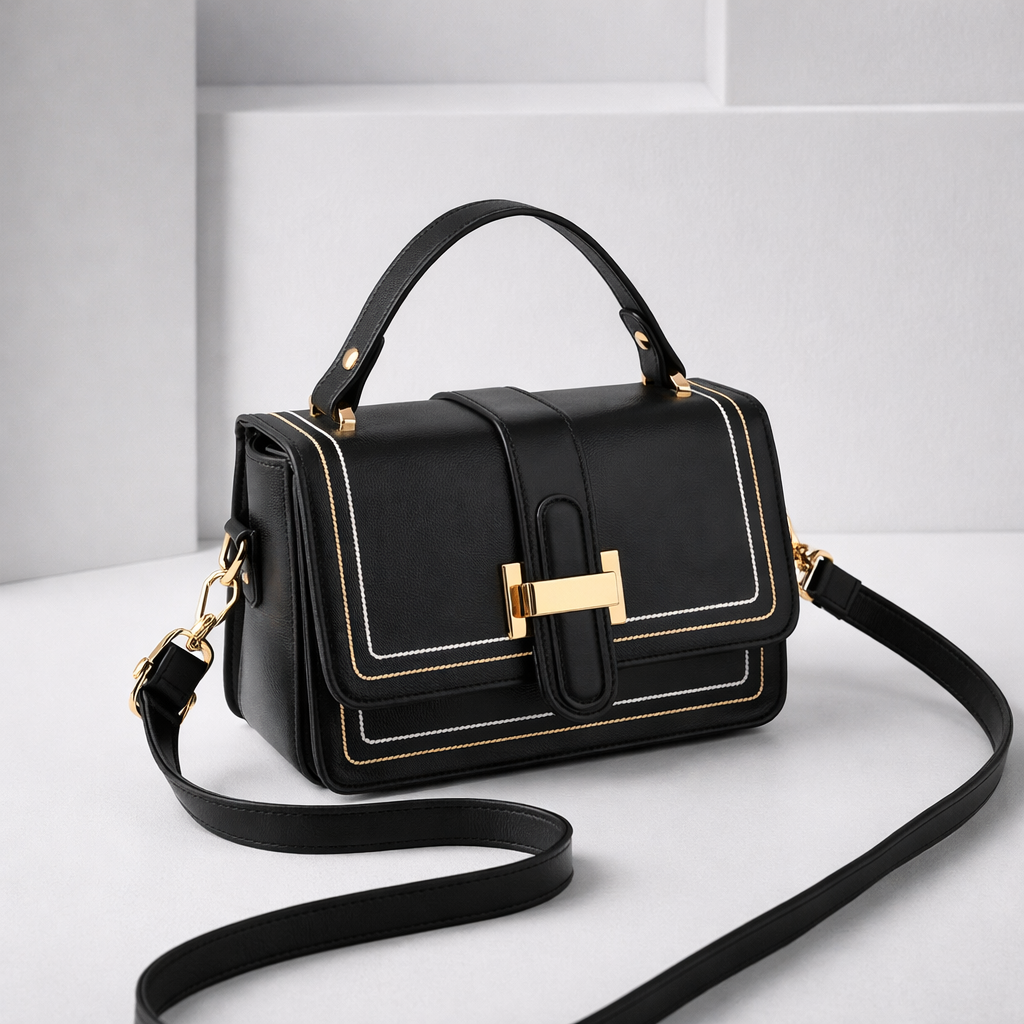 Black version with gold clasp and white and gold stitching, angled view with the strap curled on a light studio background. 5