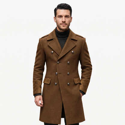 Model in the brown double-breasted overcoat with metal buttons and suede-look cuffs, worn over a black roll-neck jumper 1