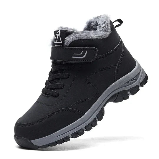 Black high-top boot with fleece-lined collar, hook-and-loop strap, laces and chunky grey tread sole, shown from the side 1