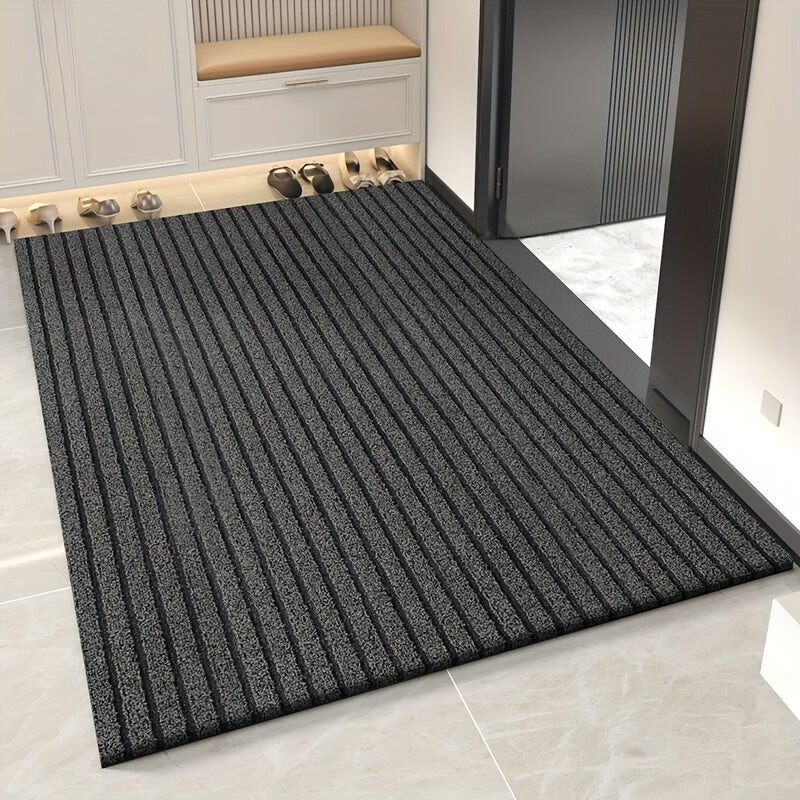 Dark grey striped looped-pile mat laid on pale tiles in a hallway, with shoes lined up beside a bench. 1