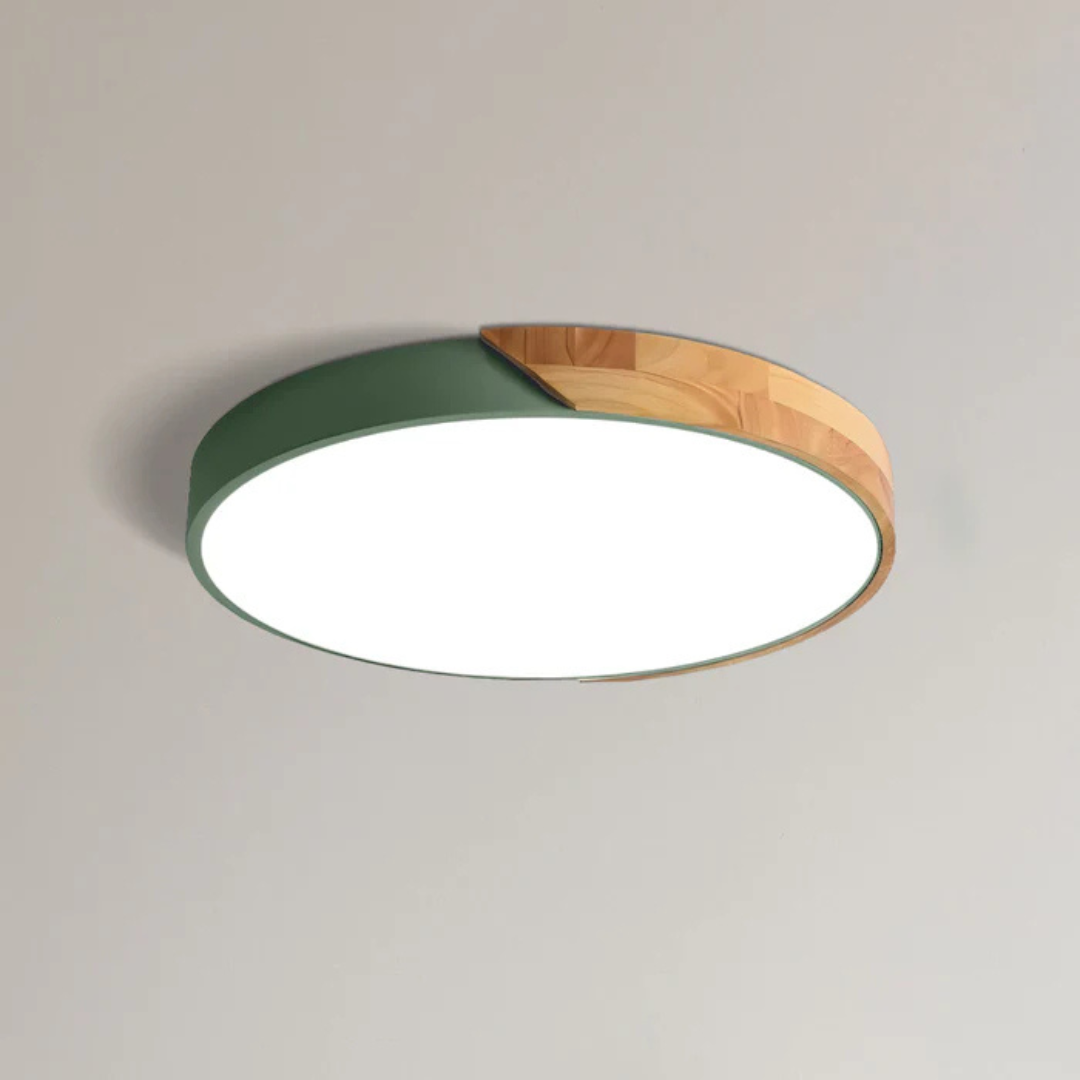 Green and wood round ceiling light shown close up on a plain ceiling, lit 13
