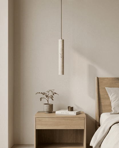 Slim stone cylinder pendant switched off, hanging above a wooden bedside table in a calm bedroom 1