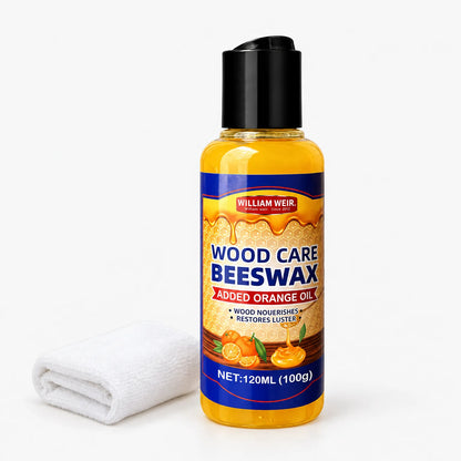 Single amber bottle of wood polish with black flip cap beside a folded white cloth 1
