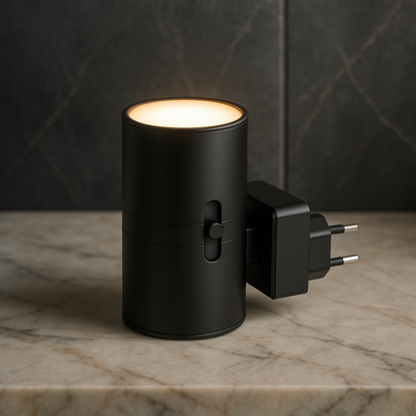 Matte black cylindrical light with a side slider and plug, standing on a marble surface with its warm top glowing. 3