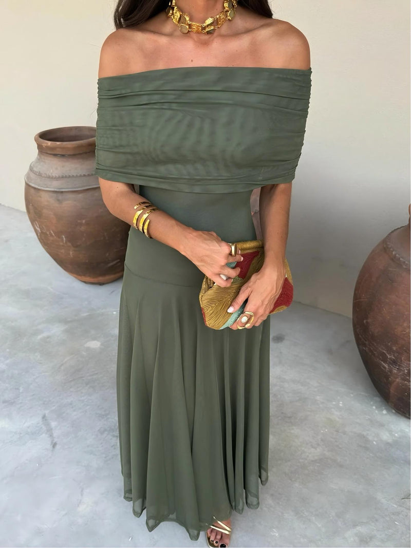 Close-up of the olive green ruched off-shoulder neckline and fitted bodice, with beaded clutch 3