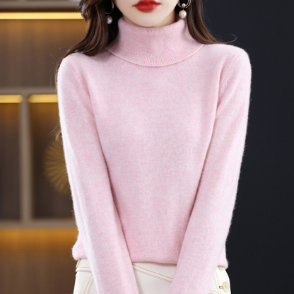 Pale pink marl roll-neck jumper worn by a model with a cream skirt, showing the generous folded ribbed collar. 8