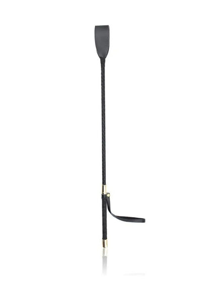Full-length view of the black crop standing upright, showing the flat tip, braided shaft, gold-toned collars and dangling wrist strap. 4