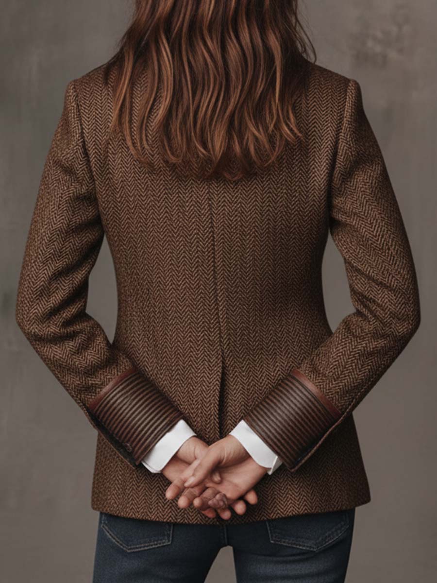 Model with hands clasped behind her back, showing the herringbone back panel and striped cuffs 11