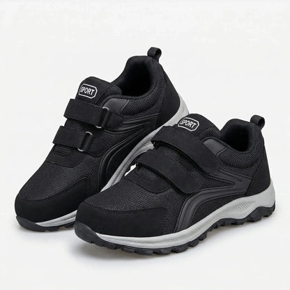 Pair of black shoes with grey soles and double straps, shown at an angle on a white background 5