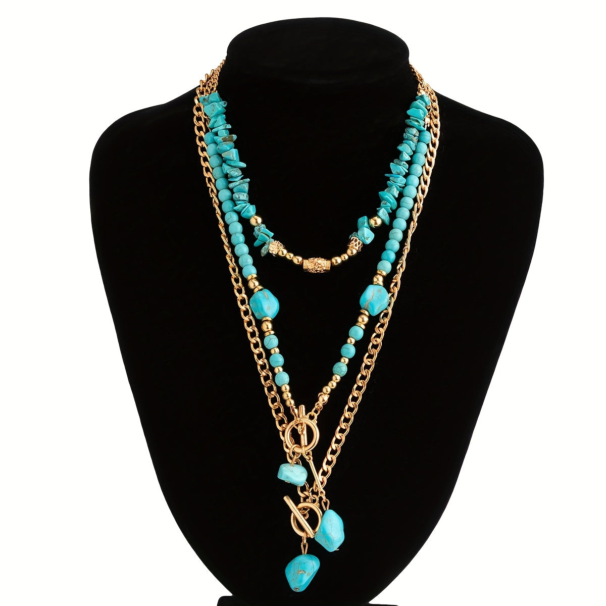 Three layered necklaces displayed on a black velvet bust, with stone drops hanging from the toggle clasps 3