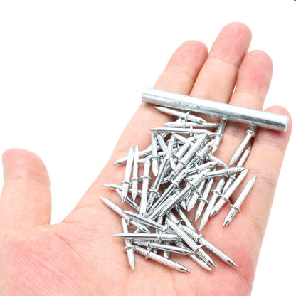 Handful of silver double-pointed nails and a metal sleeve tool resting on an open palm, showing how small they are. 1