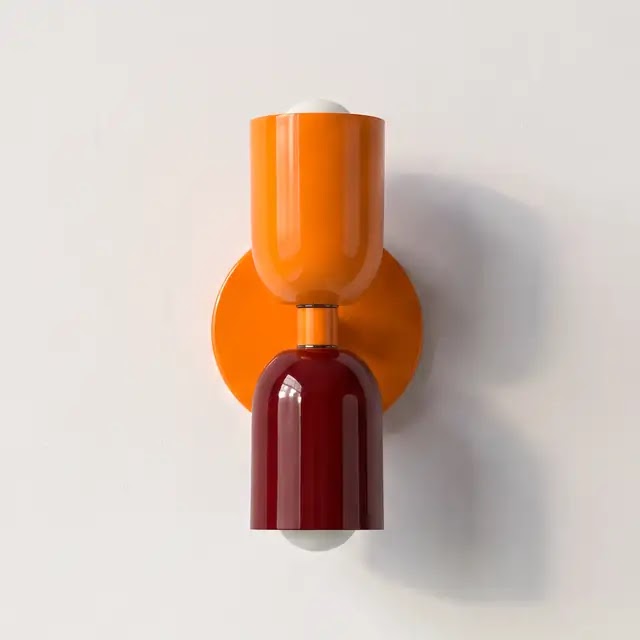 Wall lamp with a bright orange upper shade and orange backplate, paired with a glossy burgundy lower shade. 25