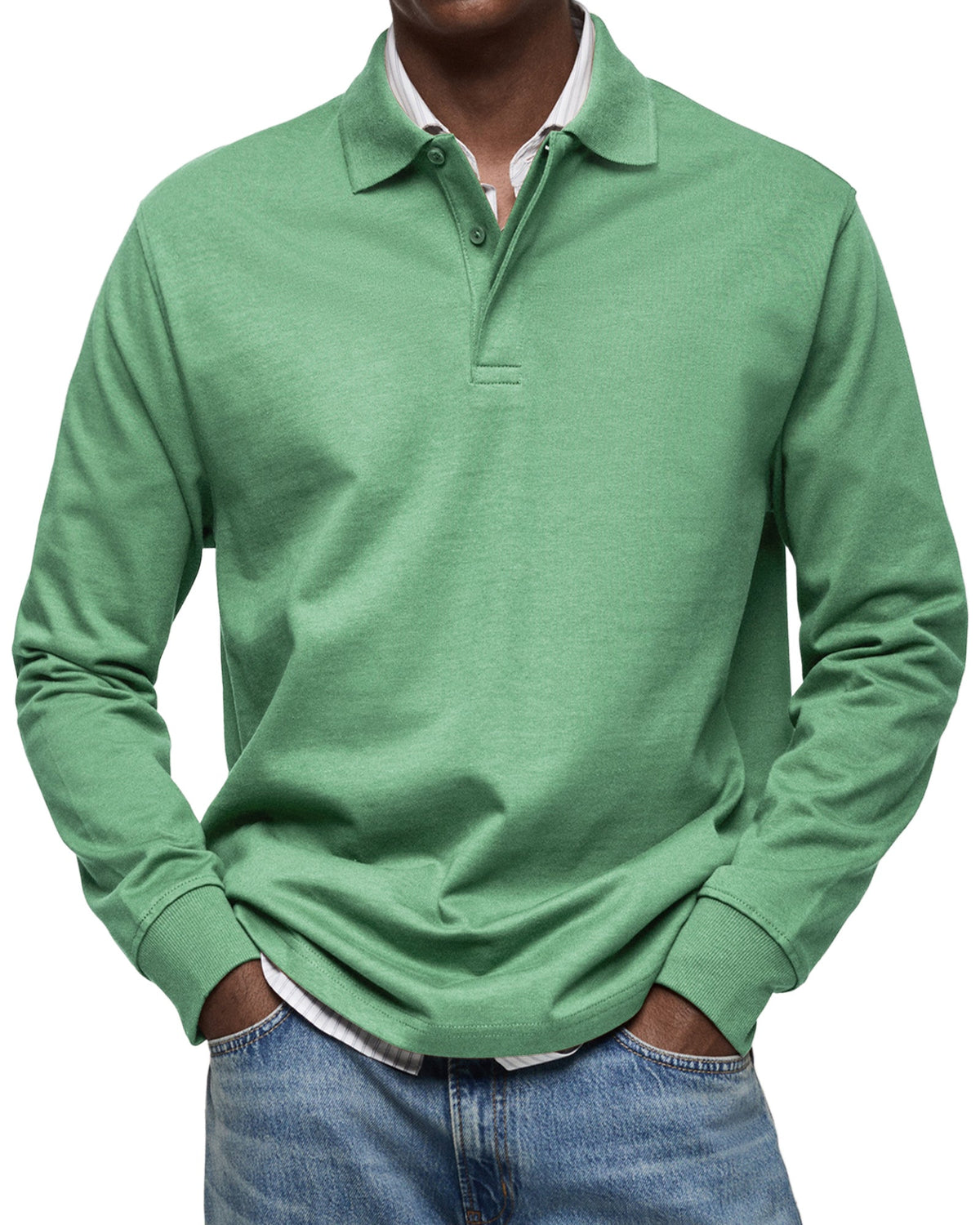 Front view of the polo in green on a model, showing the buttoned collar and ribbed cuffs over a striped shirt. 7