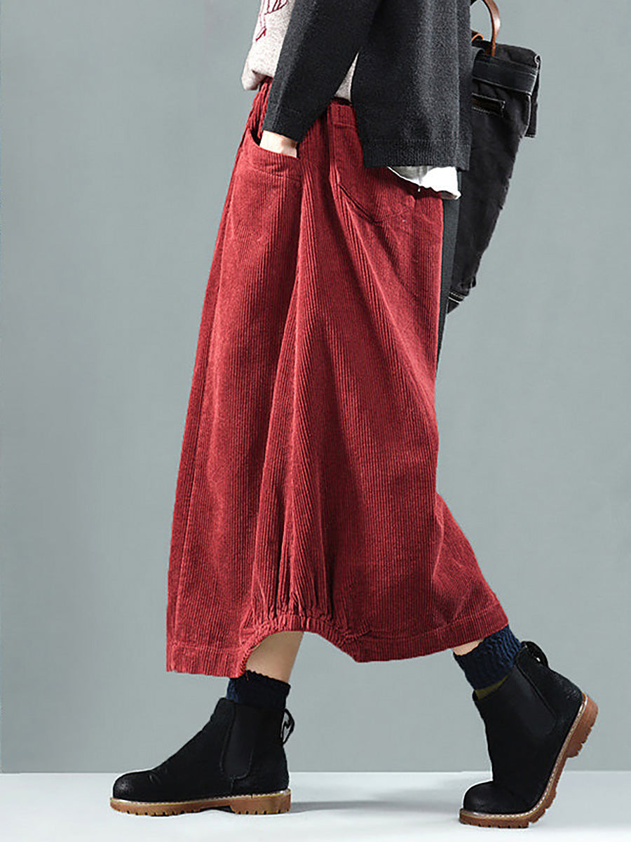 Side view of the red skirt on a model, showing the large pocket and gathered hem 2