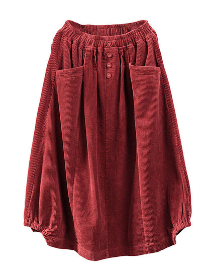 Red corduroy skirt laid flat, showing the elastic waistband, three buttons and two large pockets 6