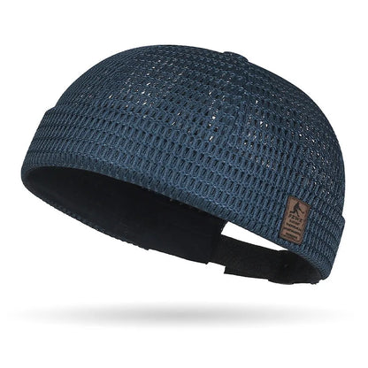 Navy open weave brimless cap with a brown patch on the cuff and black back strap 20