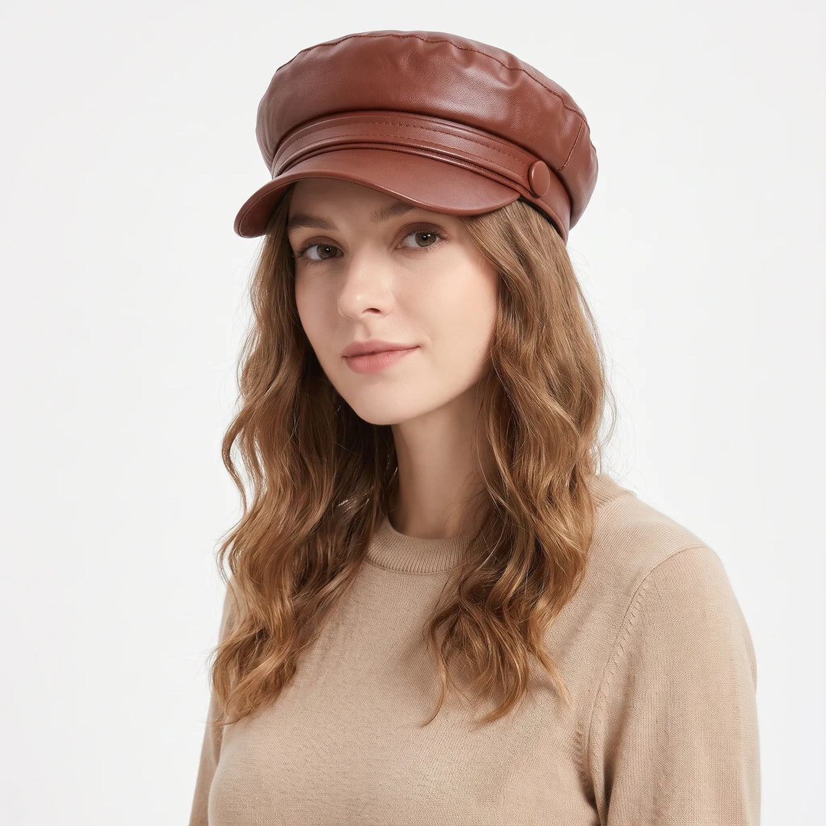 Woman with wavy hair wearing the brown baker boy hat with a beige knit jumper 20