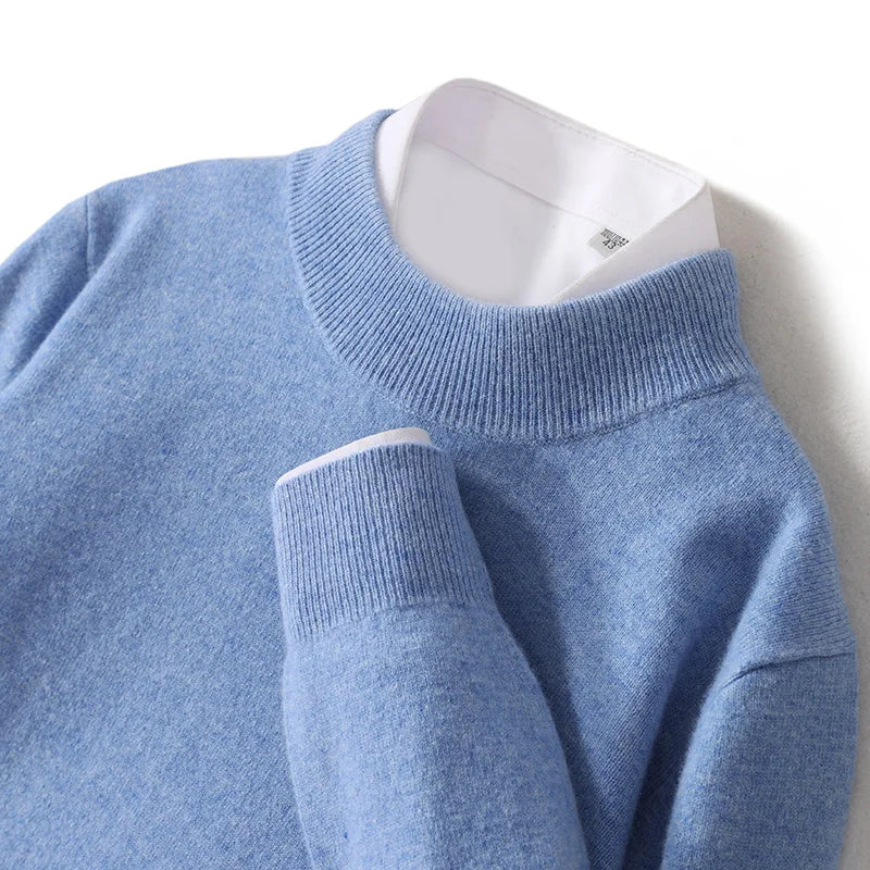 Close-up of the light blue jumper's ribbed mock neck and folded cuff with white shirt below 20