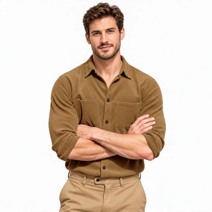Smiling model with arms crossed wearing the tan ribbed shirt against a plain white background 20