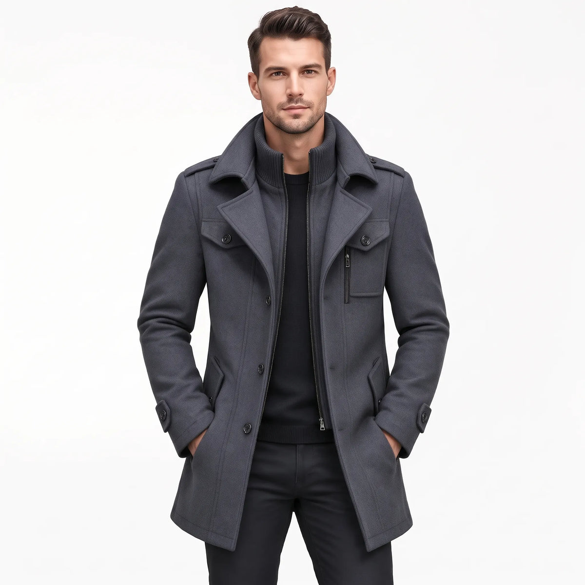 Man wearing the grey coat open over a black jumper and black trousers, hands in pockets 20