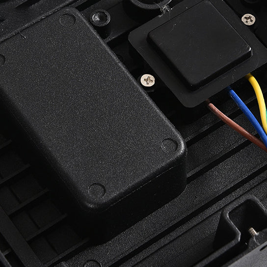 Close-up of the internal wiring and black electronic components fixed inside the base of the light. 7