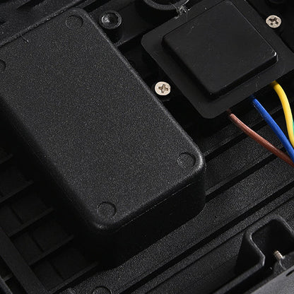 Close-up of the internal wiring and black electronic components fixed inside the base of the light. 7