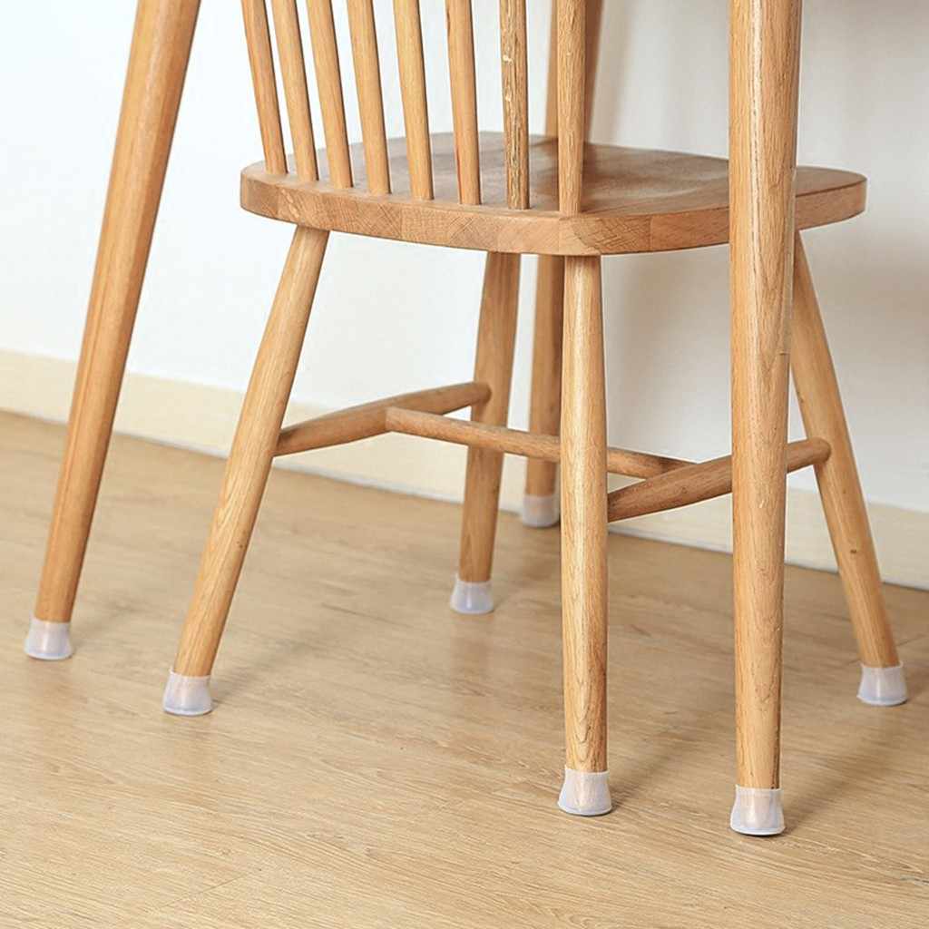 Wooden chair on a pale wooden floor with clear silicone caps fitted on the bottoms of all its legs. 5