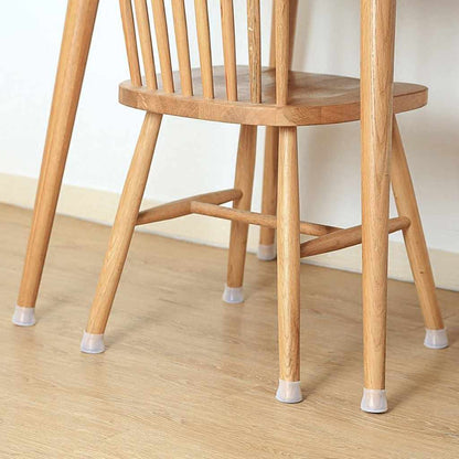 Wooden chair on a pale wooden floor with clear silicone caps fitted on the bottoms of all its legs. 5