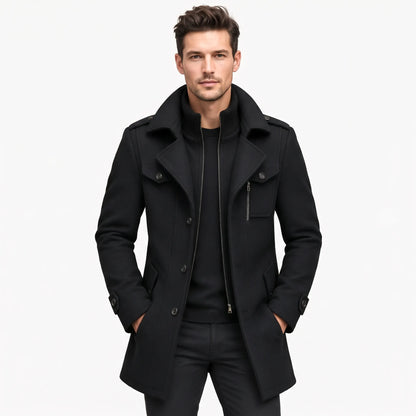 Front view of a man wearing the black coat unfastened over a black jumper, hands in pockets 21