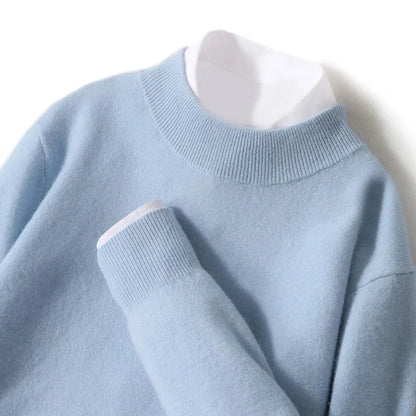 Close-up flat lay of the pale blue knitted jumper with ribbed mock neck and cuff, white shirt underneath 21