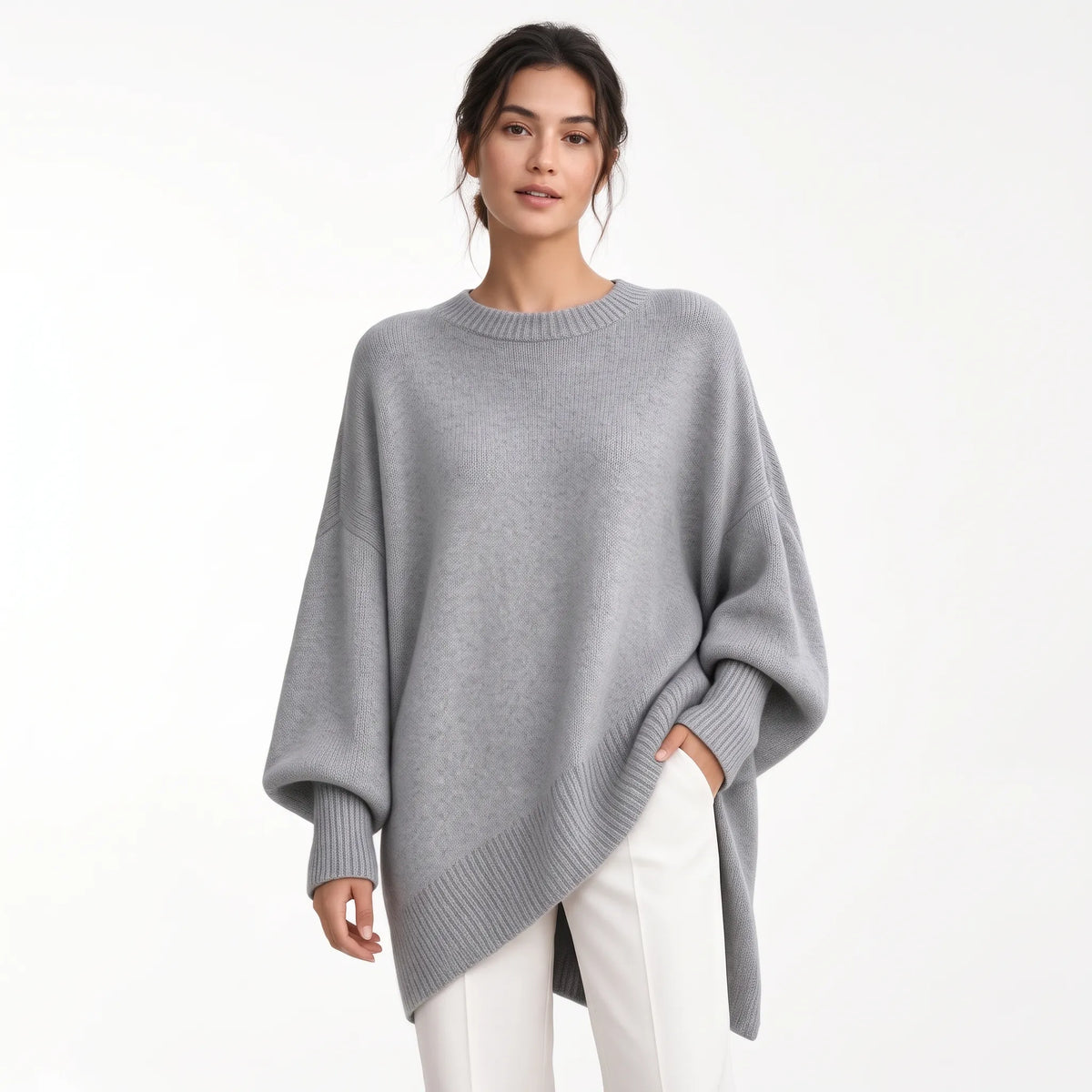 Model wears the oversized grey knit with ribbed trims and balloon sleeves, styled with white trousers 21