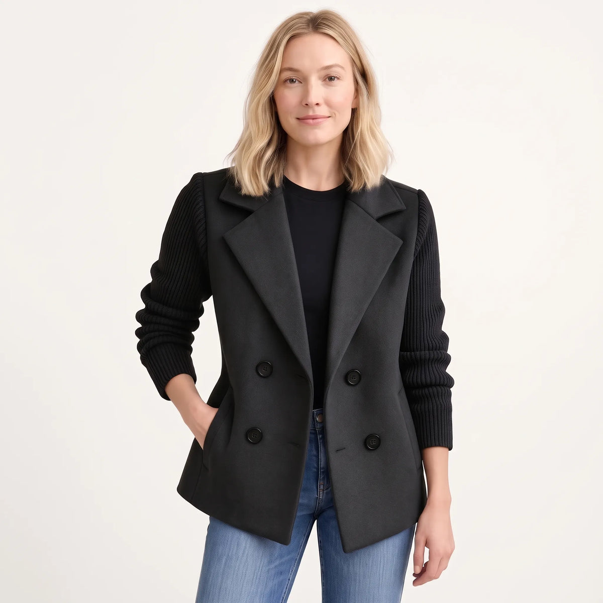 Model wearing the black jacket open over a black top and jeans, with ribbed knit sleeves 21