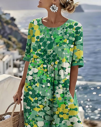 Upper-body detail of the green floral dress showing round neckline, gathered waist and short sleeves 8
