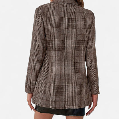 Close-up of the back of the brown check blazer on a model, showing the woven pattern and fitted shape. 4