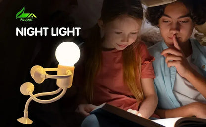 Glowing figure light with suction-cup limbs beside two children reading a book in the dark 22
