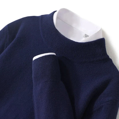 Close-up flat lay of the navy knitted jumper showing ribbed mock neck and cuff over a white shirt 22