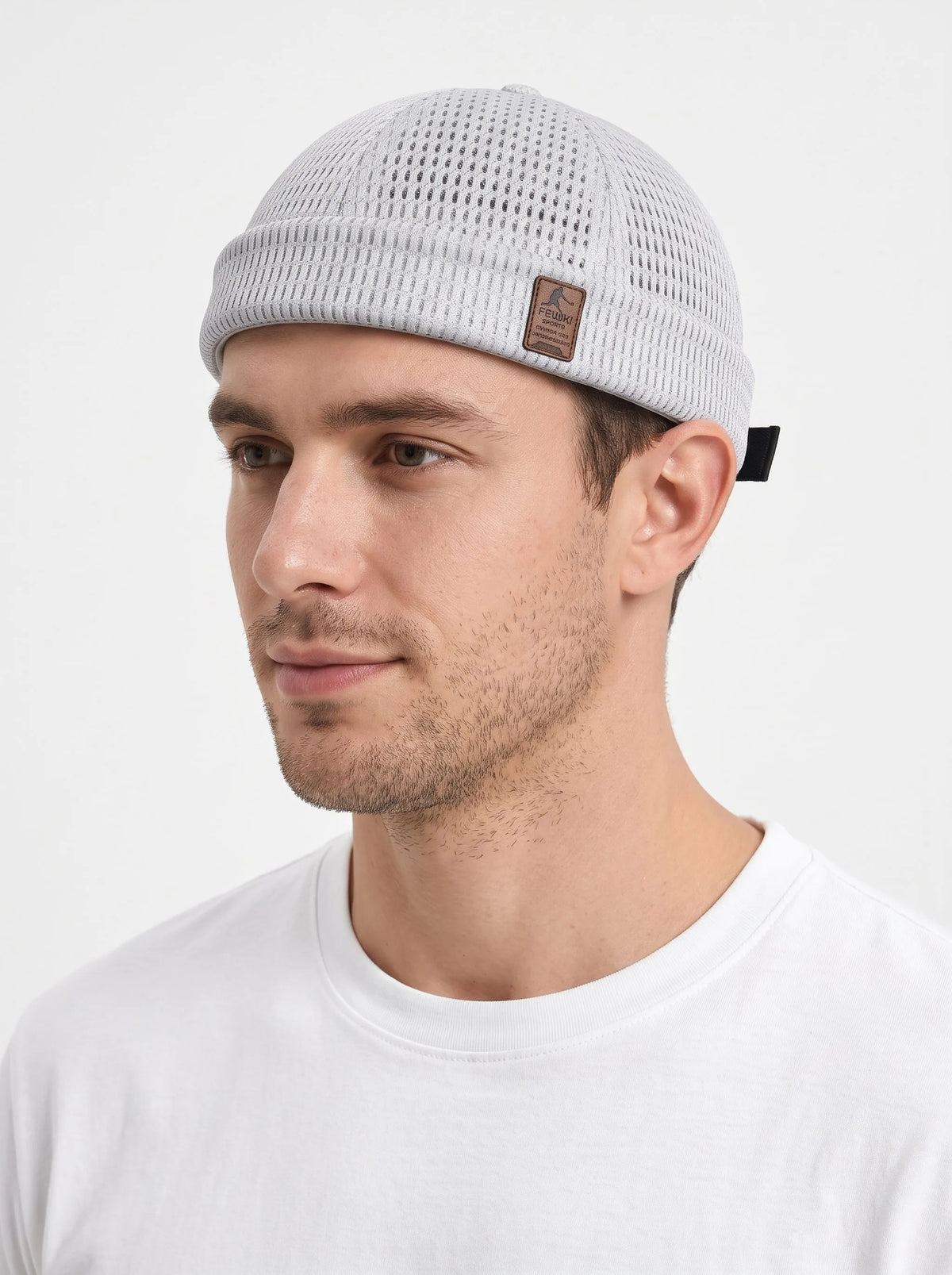 Man in a white t-shirt wearing the light grey open weave brimless cap, close side view 23