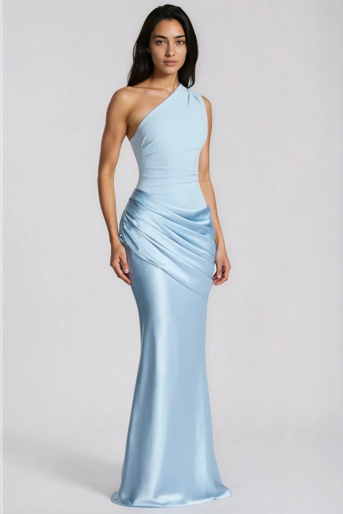 Full-length front view of the pale blue one-shoulder dress on a model with arms relaxed, showing the fitted bodice and satin skirt. 3