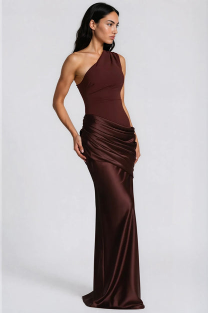 Three-quarter side view of the brown one-shoulder dress, showing the fitted bodice, layered satin drape and floor-length skirt. 8
